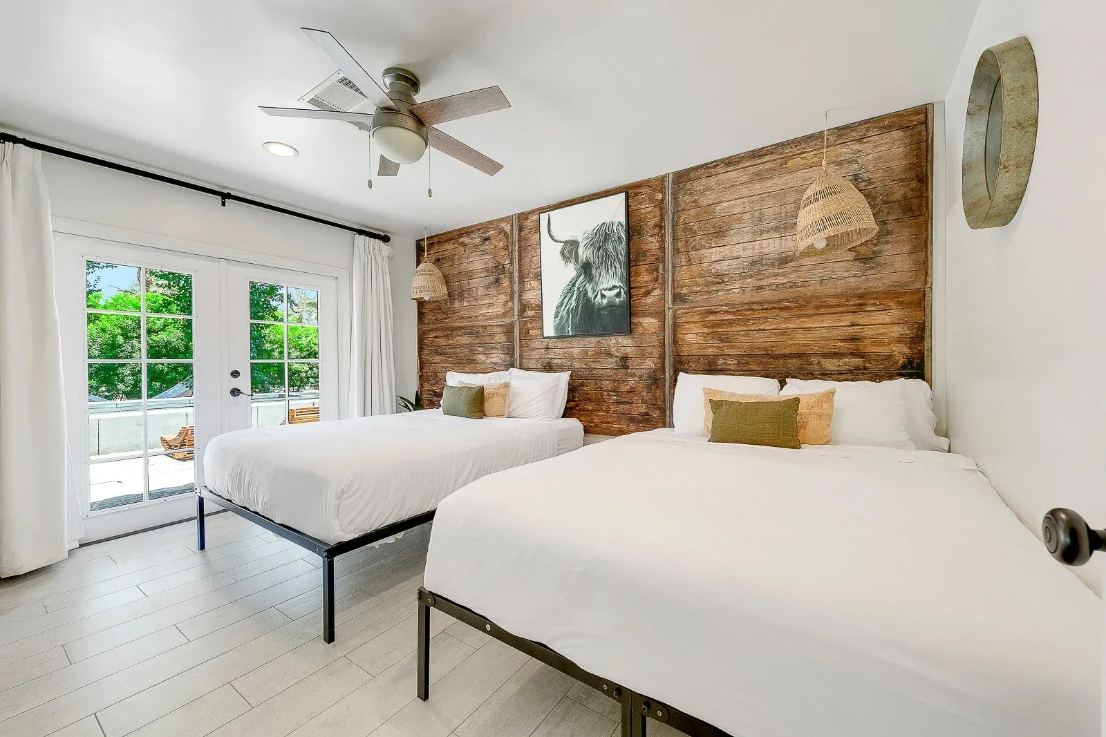 A guest room with a timber headboard