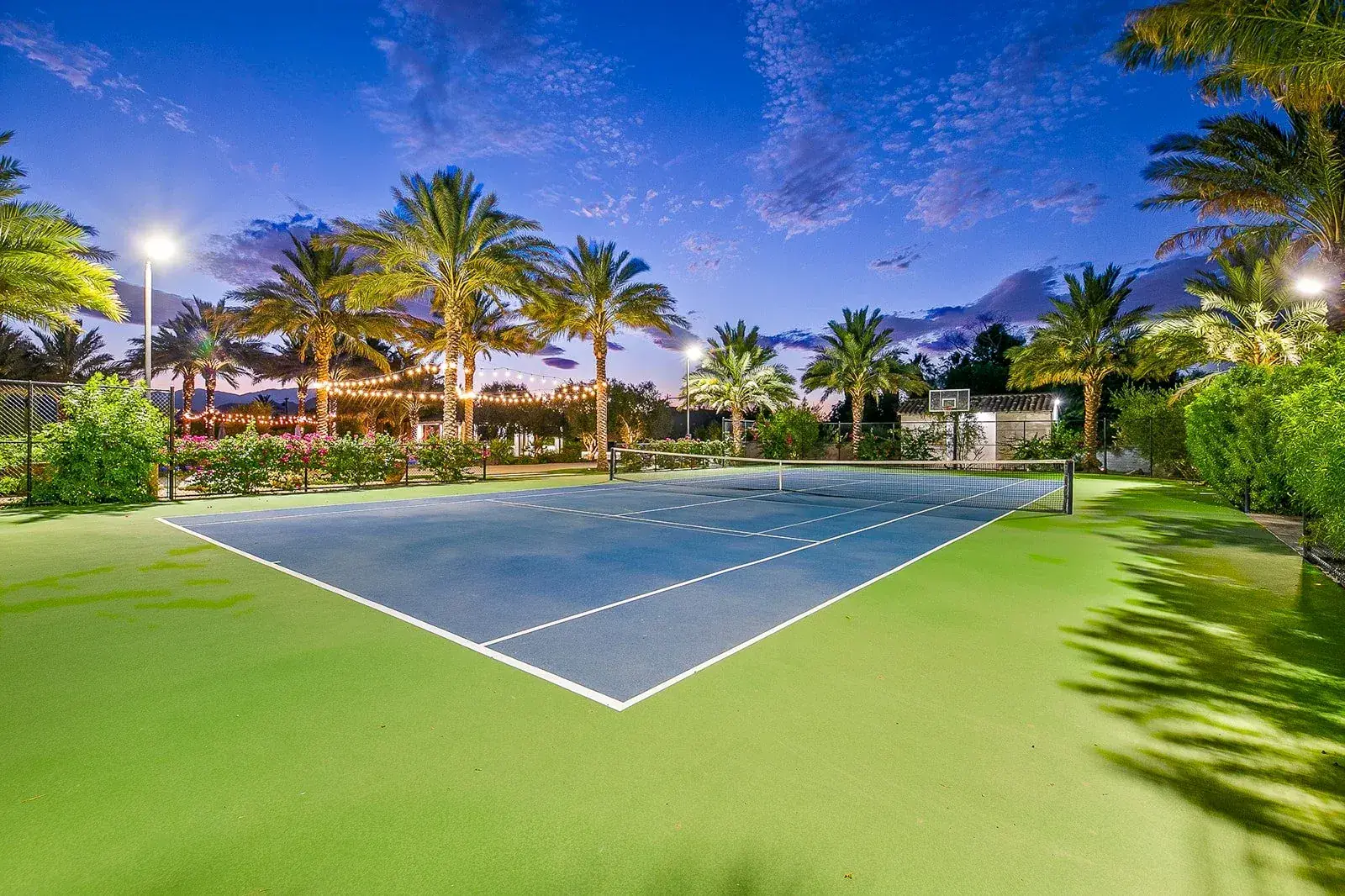 The floodlit tennis court at night