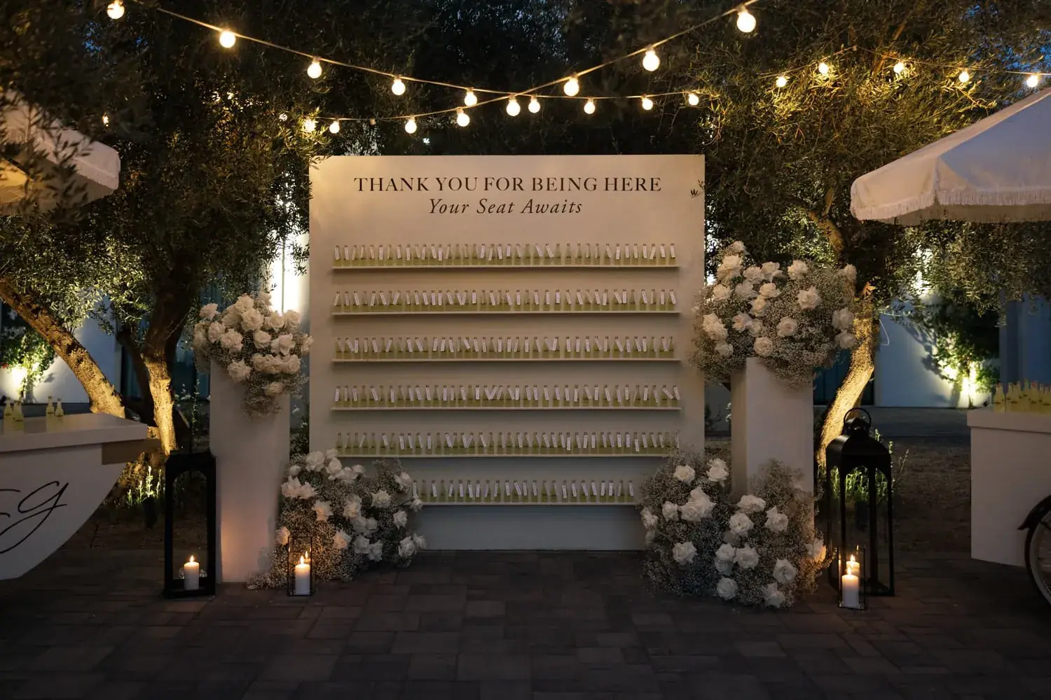 Escort card wall under string lights