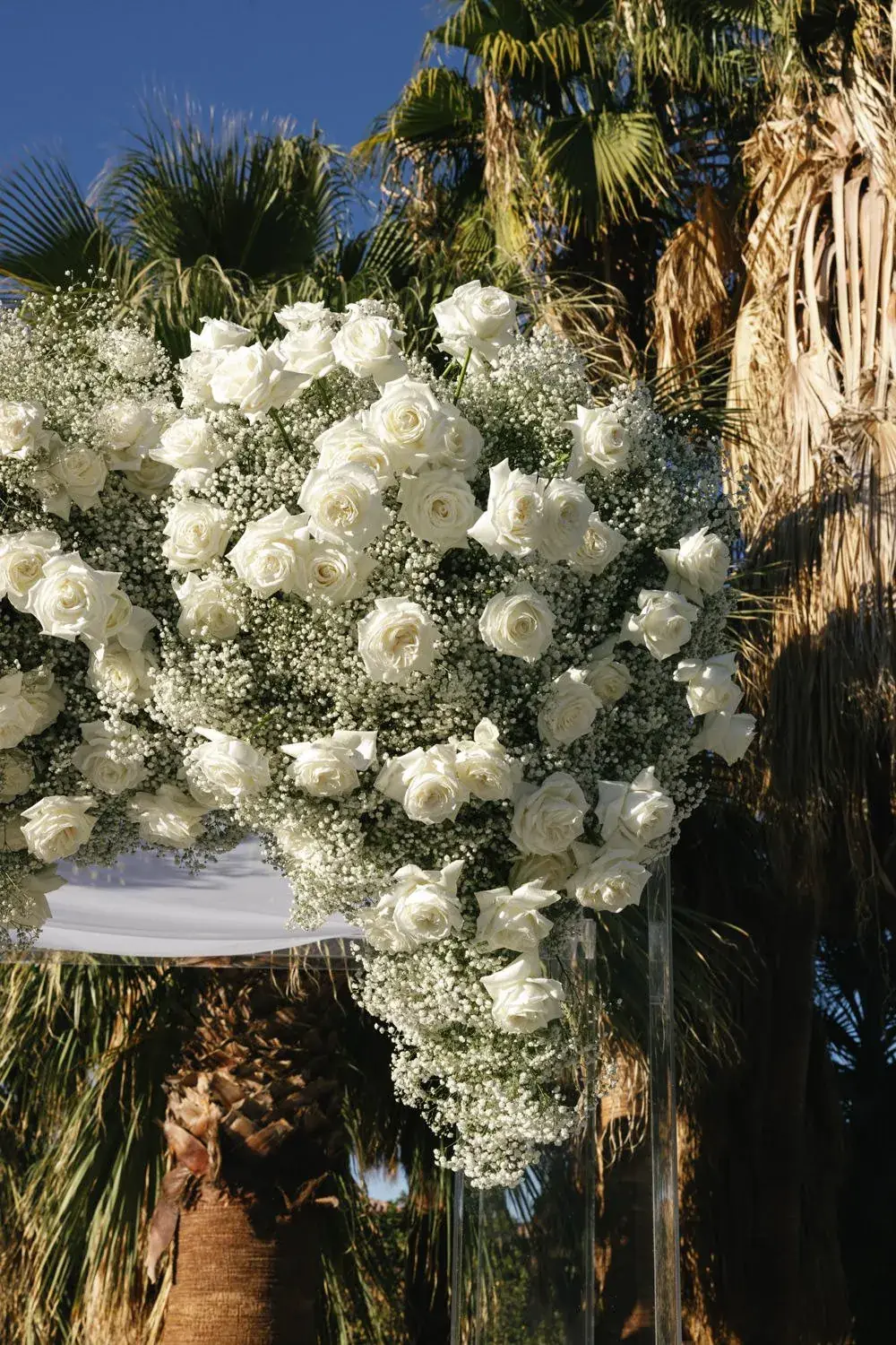 White roses and baby's breath on the chuppah