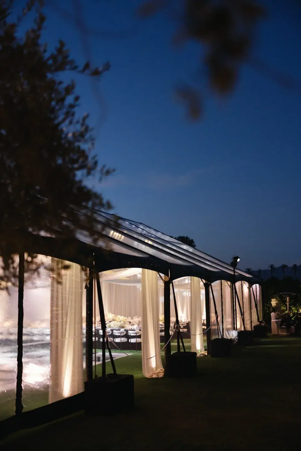 The reception tent glowing at night
