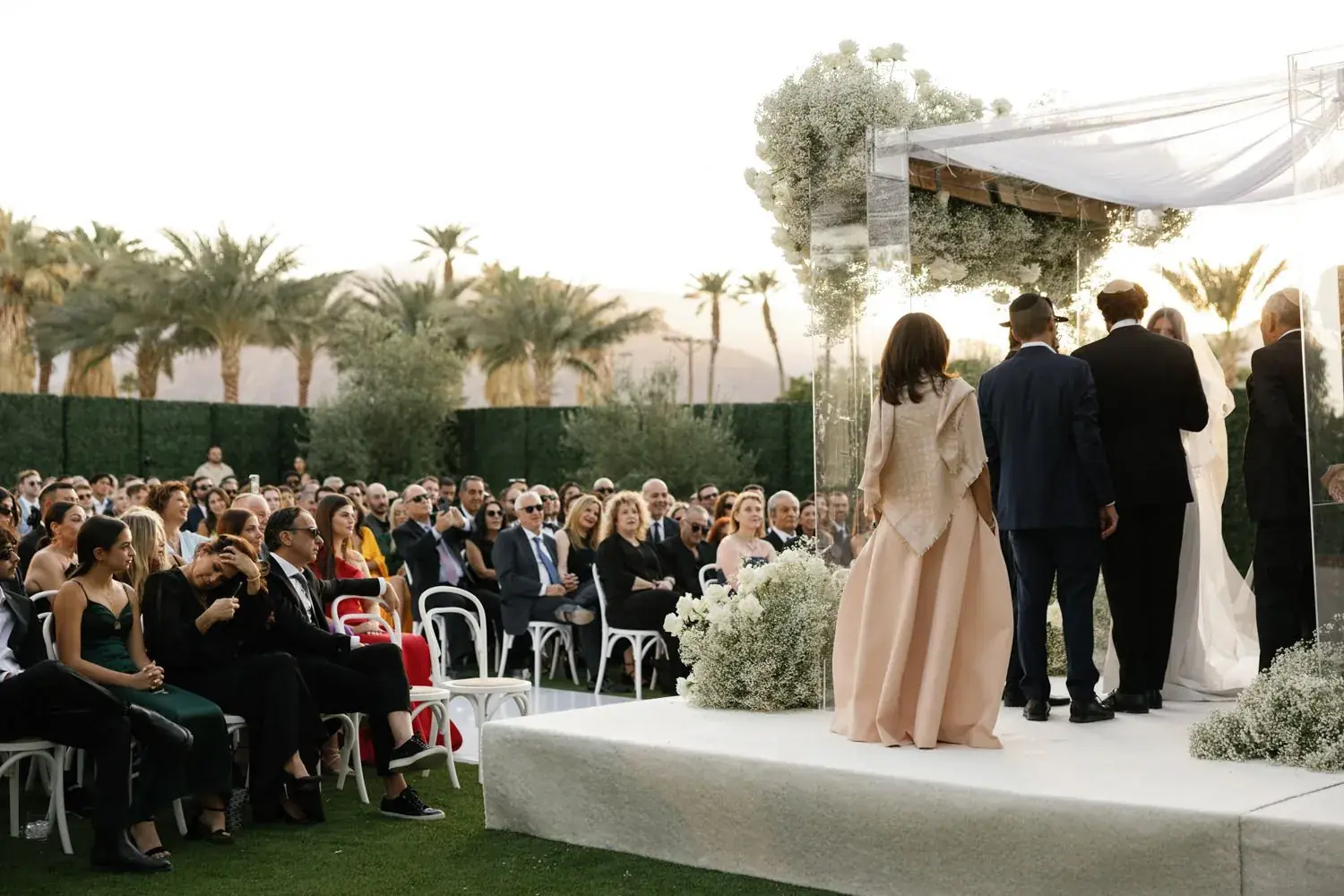Vows on the lawn before 300 seated guests